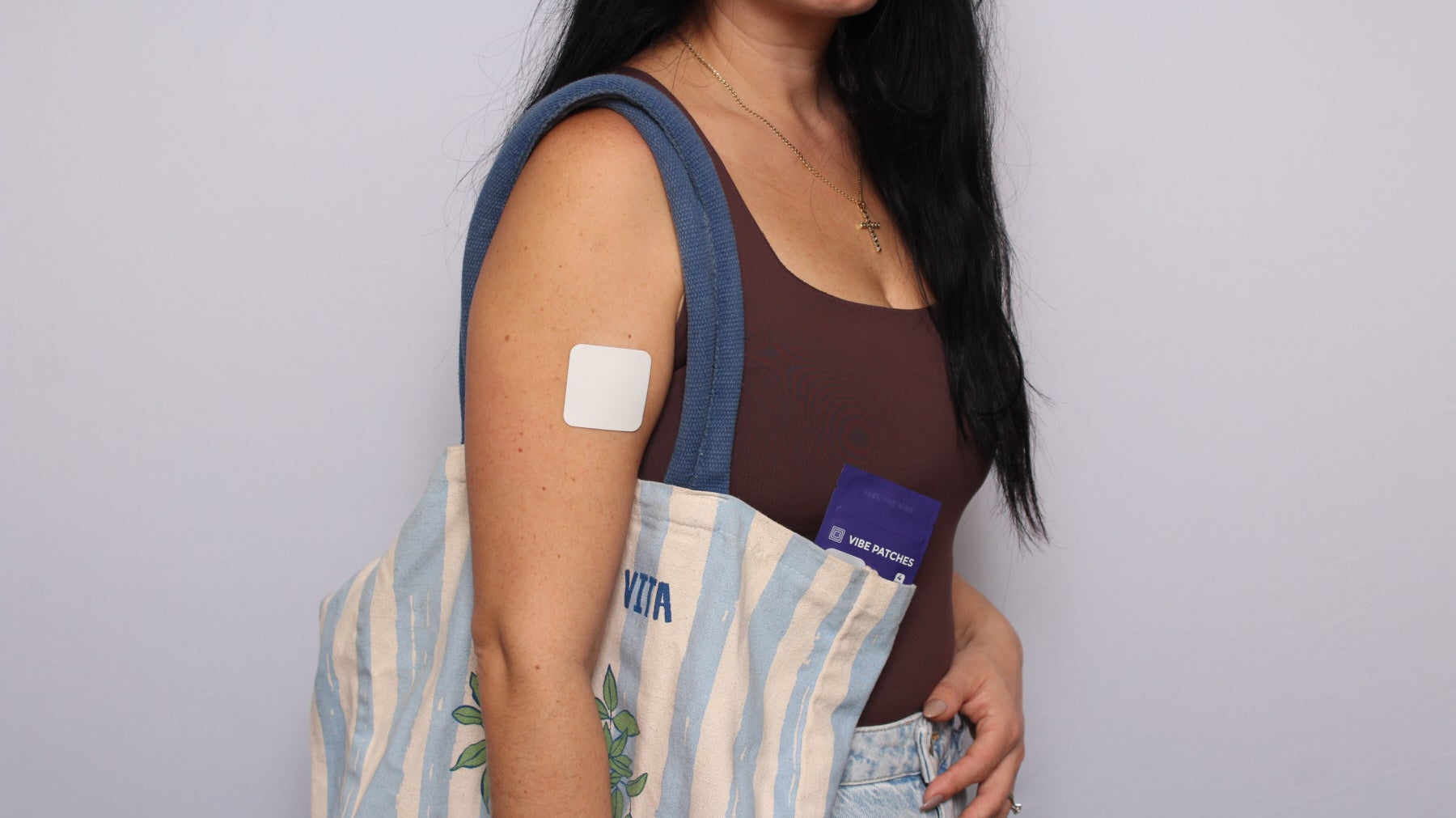 A woman with a sling bag using Vibe Patches.