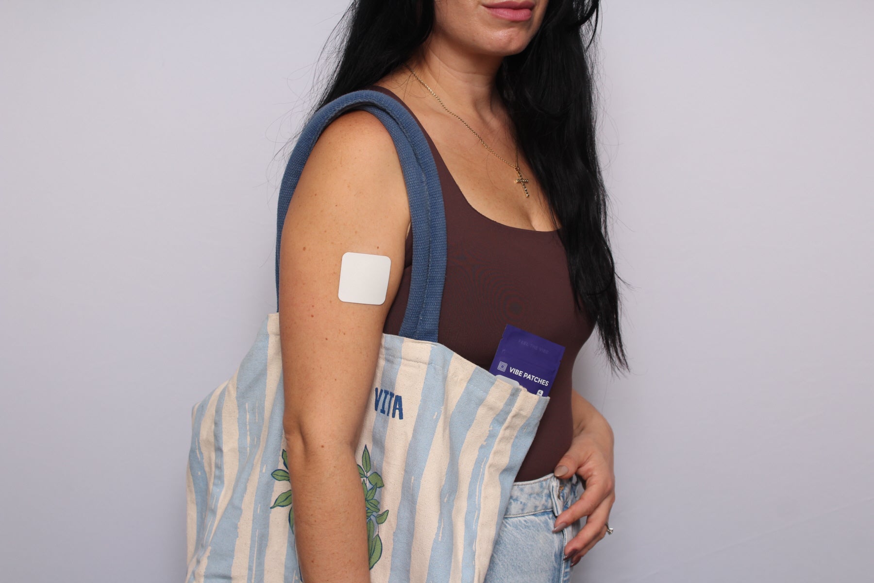 A woman with a sling bag using Vibe Patches.